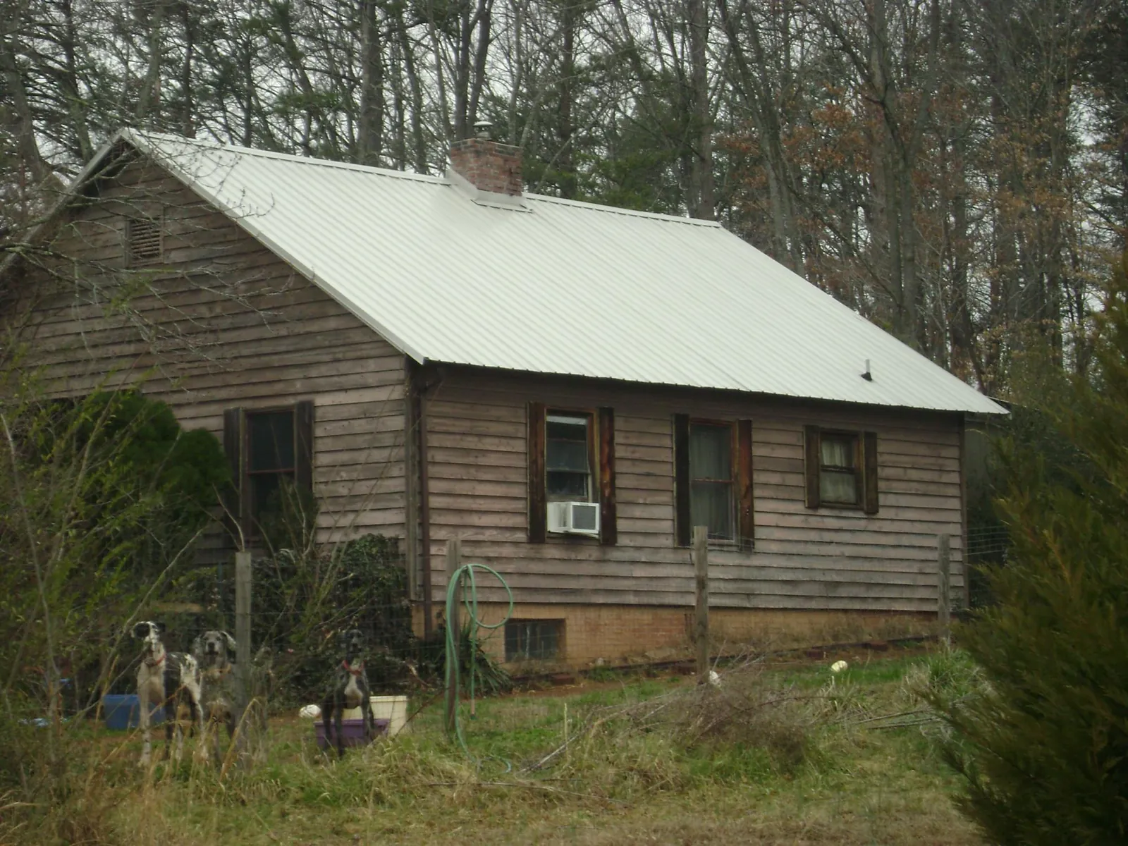 White metal roof on an old wood sided farmhouse, from a Metal Roof Installation job in Mojave